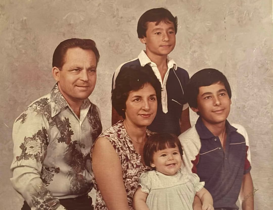 A family portrait from Karla's childhood with her parents and brothers